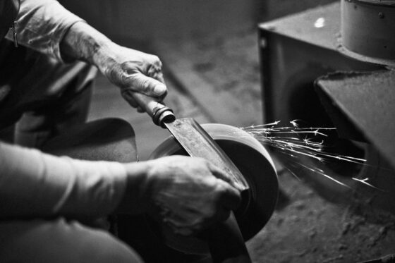 image of a man sharpening a knife